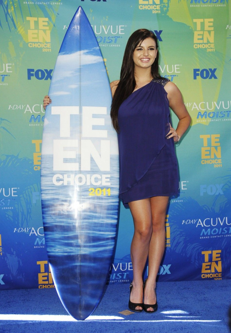 Singer Rebecca Black poses with her award in the press room backstage at the Teen Choice Awards in Los Angeles