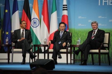 U.S. President Barack Obama (left), South Korean President Lee Myung-bak (center), and Canadian Prime Minister Stephen Harper sit during an awards presentation for small and medium sized businesses after the end of meetings at the G20 Seoul Summit on Nove