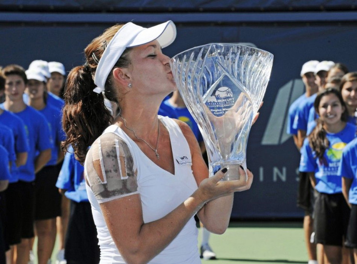 Radwanska of Poland kisses the trophy after winning her final match against Zvonareva of Russia at a WTA tennis event in Carlsbad