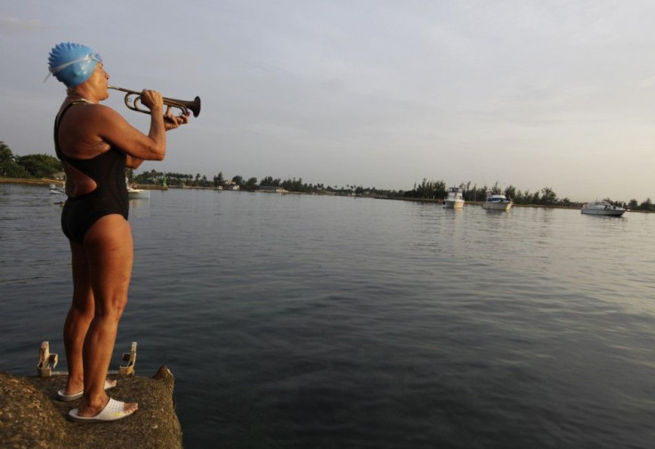 U.S. swimmer Nyad plays a trumpet before attempting to swim to Florida from Havana.