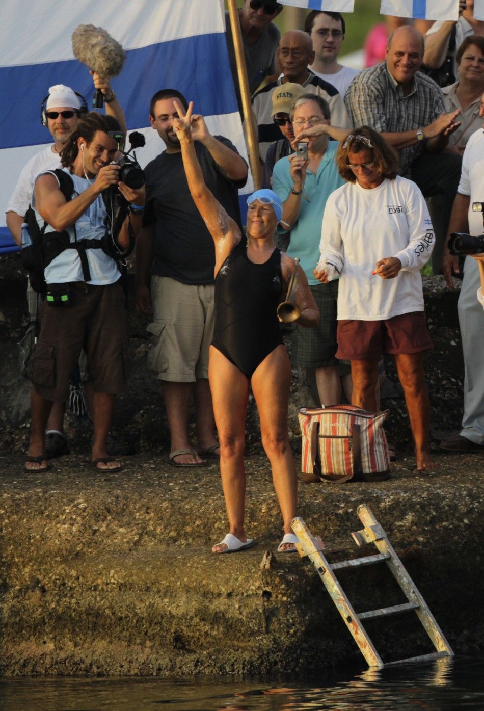 U.S. swimmer Diana Nyad flashes the victory sign before her attempt to swim to Florida from Havana.