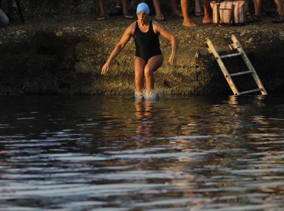 U.S. swimmer Diana Nyad jumps into the sea as she begins her attempt to swim to Florida from Havana.