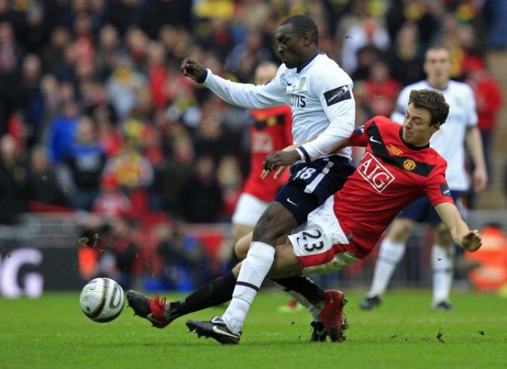 Aston Villa's Heskey is challenged by Manchester United's Evans during their English League Cup final soccer match in London on 28/02/2010.