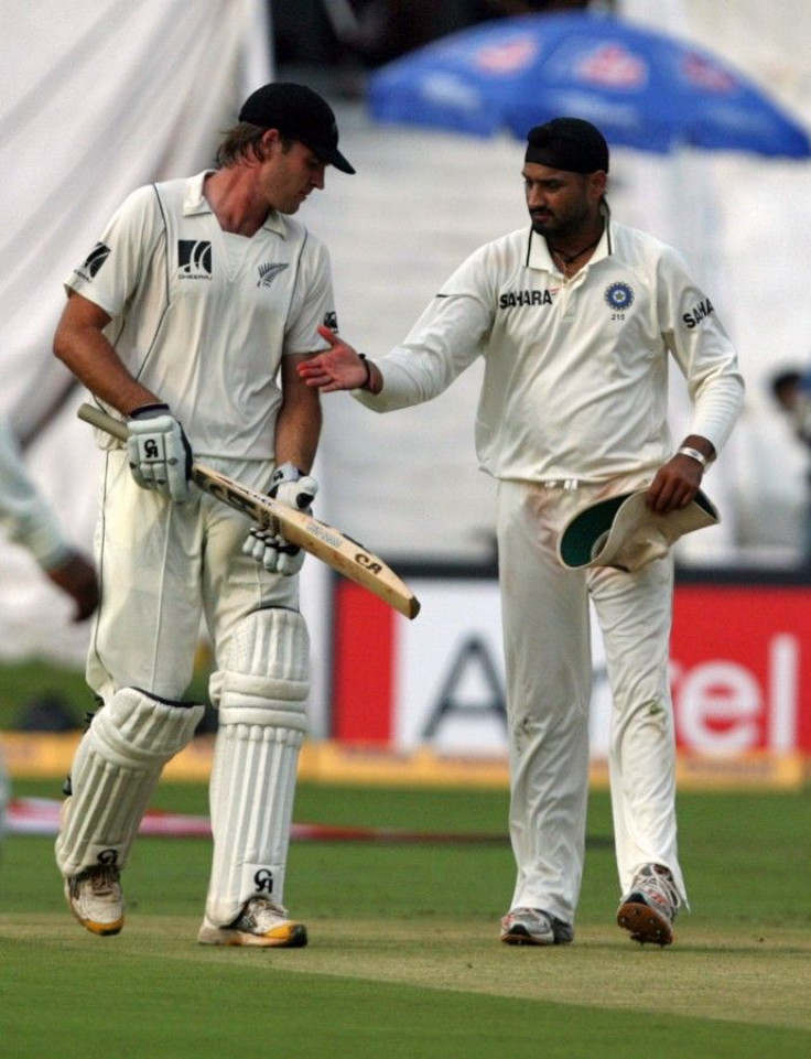 New Zealand's McIntosh is congratulated by India's Singh after he scored his century during during the first day of their second test cricket match in Hyderabad.
