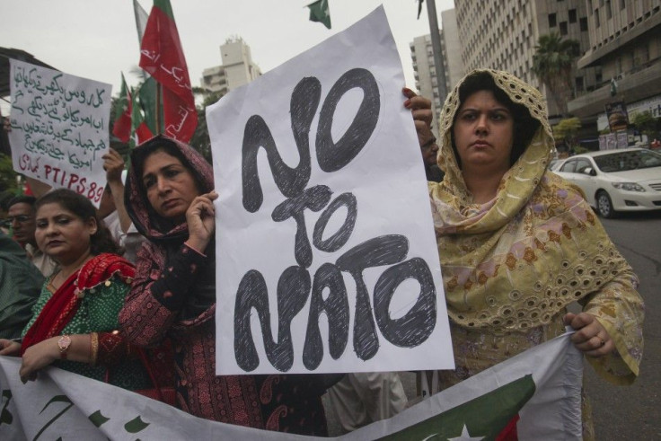 Supporters of Pakistan Tehreek-i-Insaf hold a placard while taking part in an anti-American demonstration in Karachi