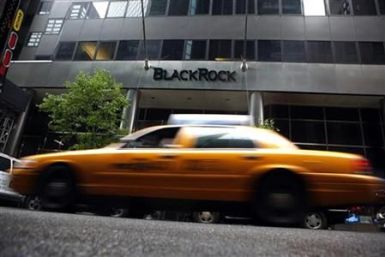 A taxi passes a BlackRock building in New York