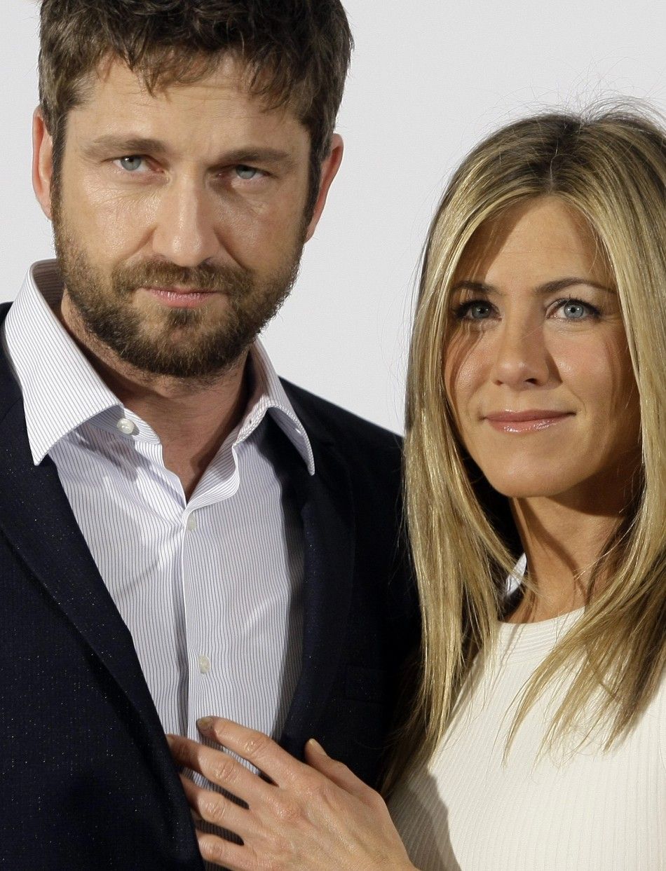 Actors Butler and Aniston pose during a photocall to promote the movie The Bounty Hunter in Madrid