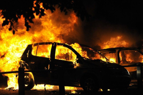 Cars burn on a street in Ealing, London