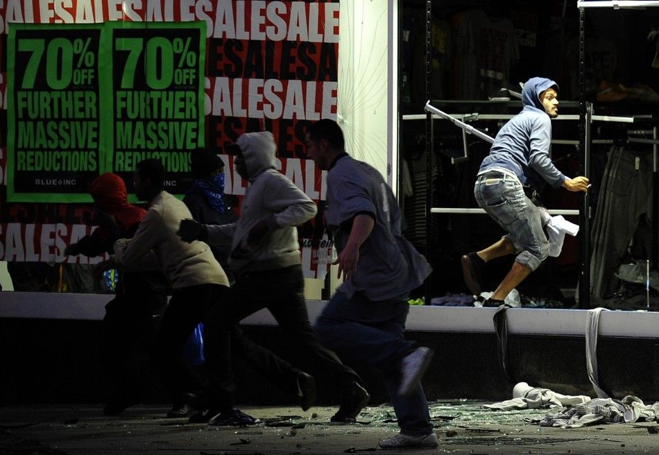 Looters run from a clothing store in Peckham, London August 8, 2011