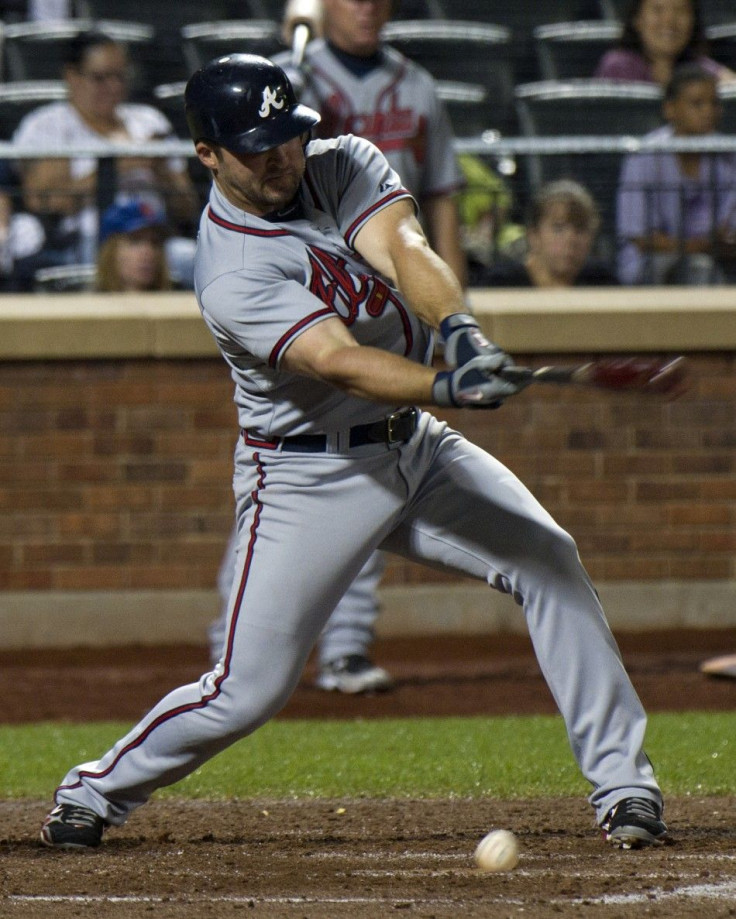 Atlanta Braves Dan Uggla hits against New York Mets to extend his hitting streak to 27 games in New York