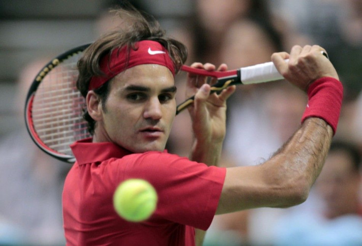 Switzerland&#039;s Federer hits a return to Portugal&#039;s Machado during their men&#039;s singles Davis Cup tennis match in Bern
