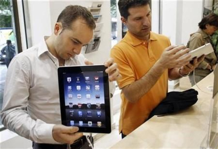 Visitors check out the new Apple iPads at an Apple retail store in Madrid
