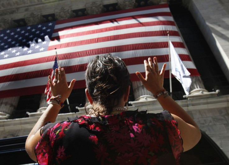 A woman does yoga outside the New York Stock Exchange