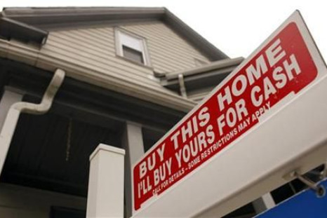 The sign on a property for sale in Somerville, Massachusetts reads &quot;Buy This Home I&#039;ll Buy Yours For Cash&quot;