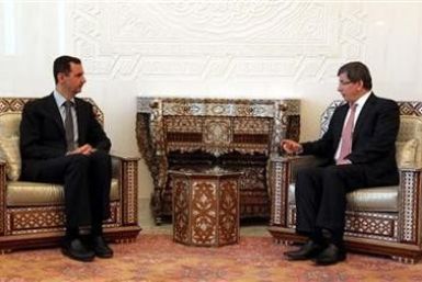 Syria&quot;s President Bashar al-Assad (L) meets with Turkish Foreign Minister Ahmet Davutoglu in Damascus