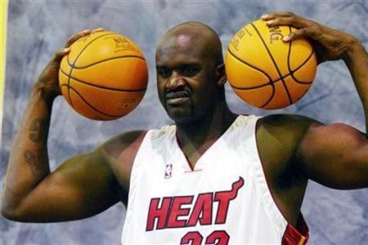 Miami Heat center Shaquille O&#039;Neal smiles as he poses for photographers during media day in Miami, Florida