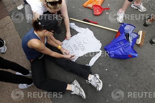 A volunteer writes on a shirt before helping to clear up in Clapham Junction, in south London