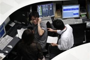 Employees of the Tokyo Stock Exchange (TSE) work at the bourse in Tokyo