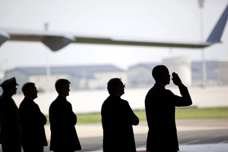 U.S. President Barack Obama salutes during a ceremony for the dignified transfer of U.S. and Afghan personnel who died in Afghanistan, at airbase in Dover, Delaware