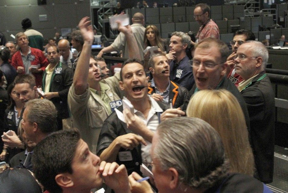 Traders signal orders at the CBOT in Chcago