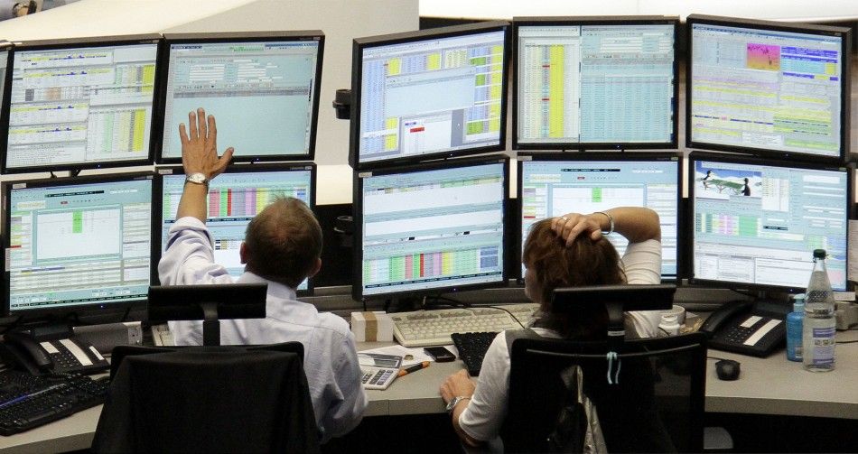 Traders work at their desks at Frankfurts stock exchange