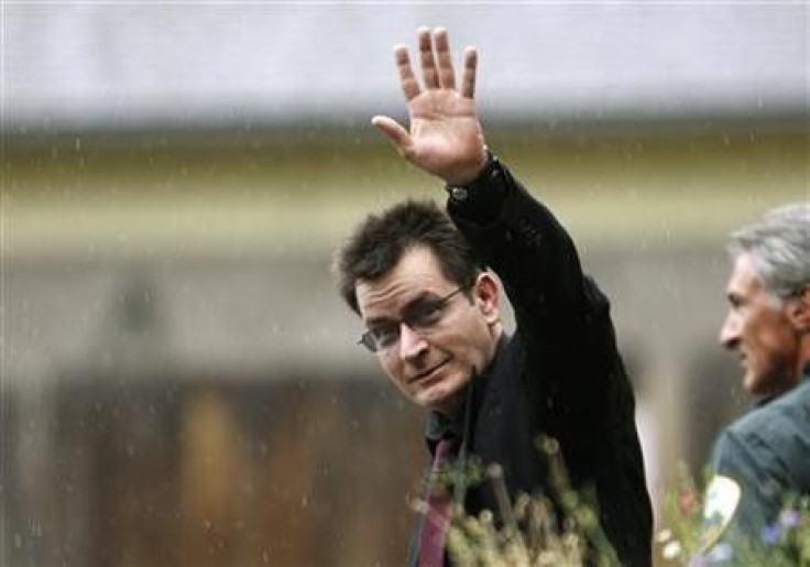 Actor Charlie Sheen gestures towards the media as he leaves the Pitkin County Courthouse after a sentencing hearing in Aspen, Colorado