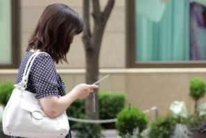 Japanese woman using her cell phone, Japan