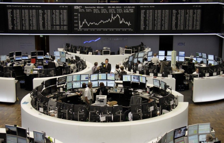 A TV crew films an interview in front of the DAX board at the Frankfurt stock exchange