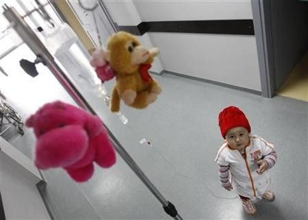 Mari, a 3 year-old leukaemia patient, stands next to her IV drip at the corridor of the onco-hematology department of the Iashvili Central Children's Hospital in Tbilisi