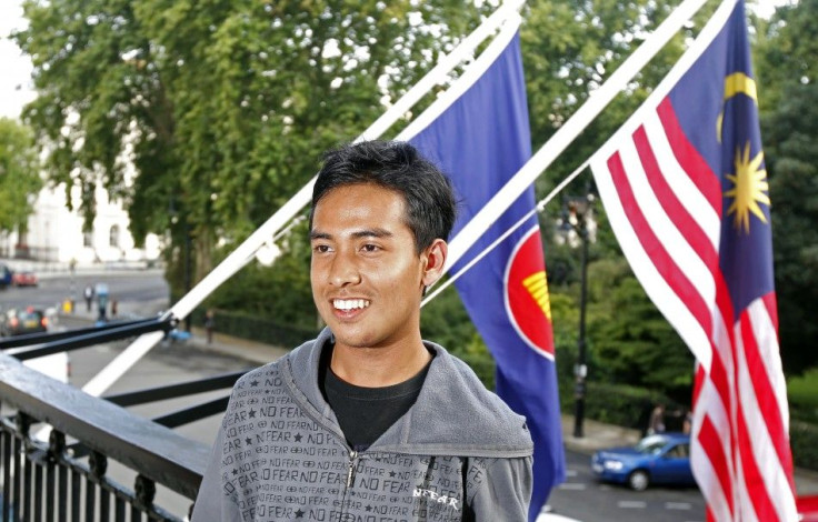 Malaysian student Asyraf Haziq Rosli, who was attacked during the London riots poses for photographs at the Malaysian High Commission in London