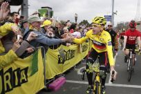 Tour de France winner Evans is congratulated by fans as he rides through the streets of Melbourne during an official homecoming ceremony