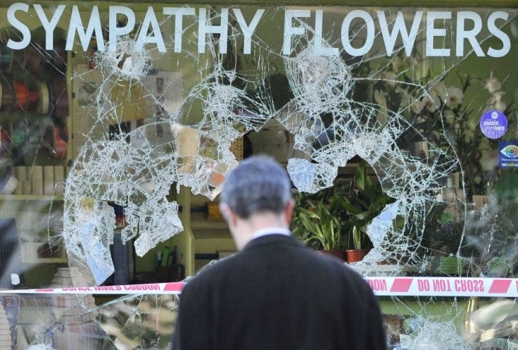 A man looks at a looted florist shop in Ealing in west London.