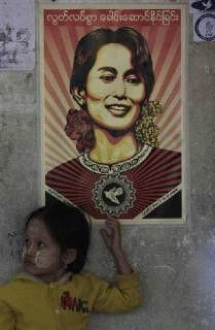 A child from Myanmar stands under a poster of Myanmar's detained pro-democracy leader Aung San Suu Kyi at the Mae Tao clinic in the Thai border town of Mae Sot November 10, 2010. 