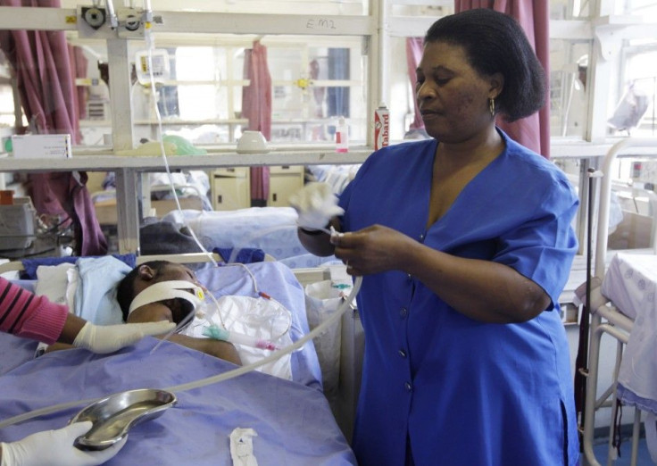 A South African mother tends to her bedridden son at the King Edward VIII hospital in Durban