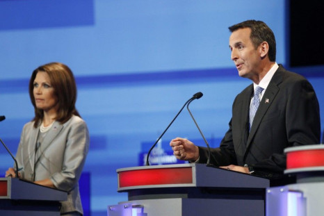 U.S. Republican presidential candidate Tim Pawlenty speaks beside Michele Bachmann during the Republican presidential debate in Ames