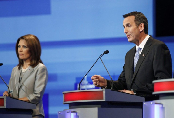 U.S. Republican presidential candidate Tim Pawlenty speaks beside Michele Bachmann during the Republican presidential debate in Ames