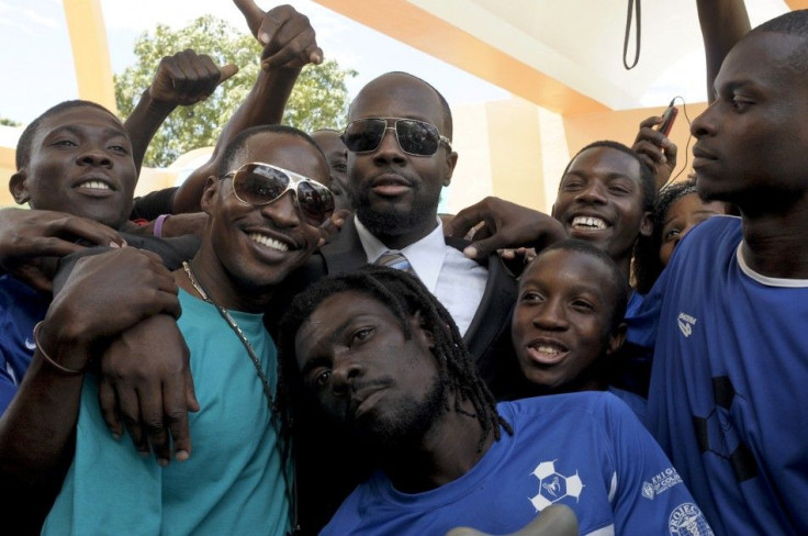 Wyclef Jean stands with members of an amputee soccer team during a ribbon cutting ceremony in Port-au-Prince