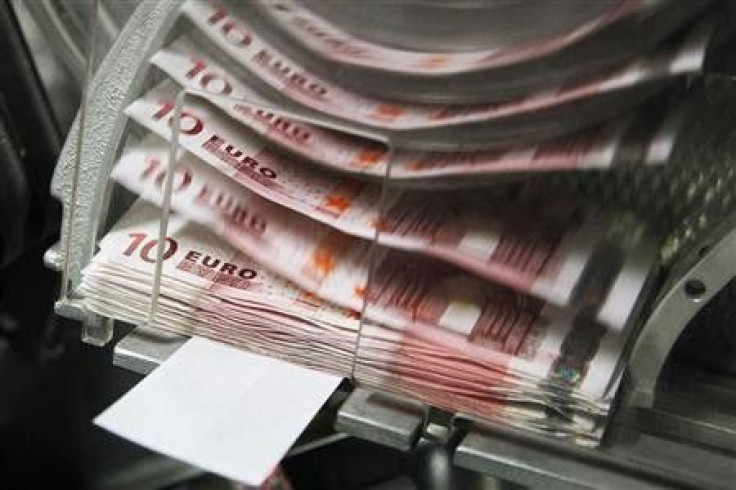 A machine counts and sorts out euro notes at the Belgian Central Bank in Brussels October 26, 2011.