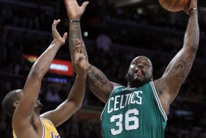 Boston Celtics center O&#039;Neal pulls down a rebound against Los Angeles Lakers forward Artest in the first half of their NBA basketball game in Los Angeles