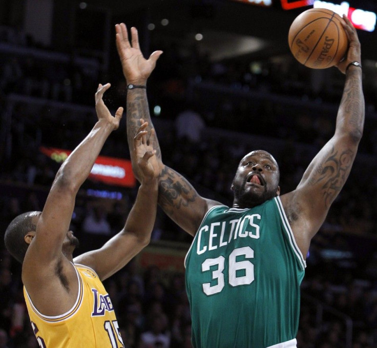Boston Celtics center O&#039;Neal pulls down a rebound against Los Angeles Lakers forward Artest in the first half of their NBA basketball game in Los Angeles