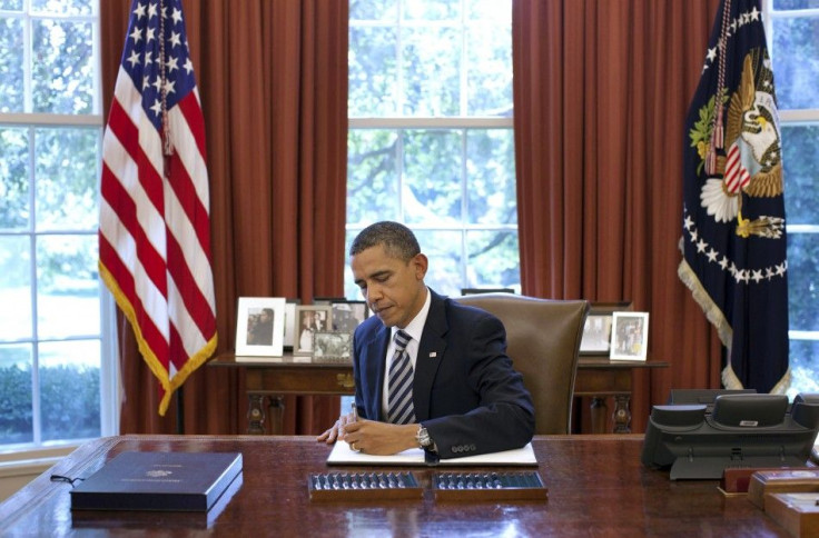 U.S. President Barack Obama signs the Budget Control Act of 2011 in the Oval Office at the White House in Washington