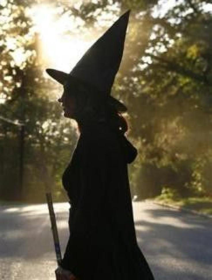 A woman dressed as a witch walks along the street during Halloween celebrations in Port Washington, New York, October 31, 2007.