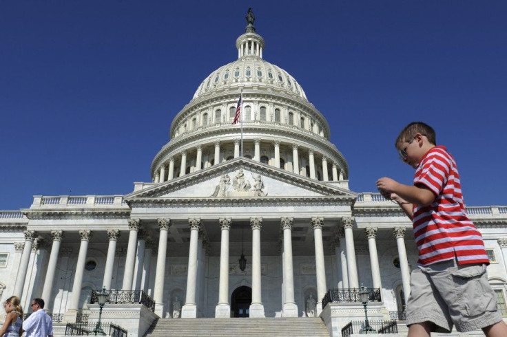 Tourists walk past the U.S. Capitol dome in Washington