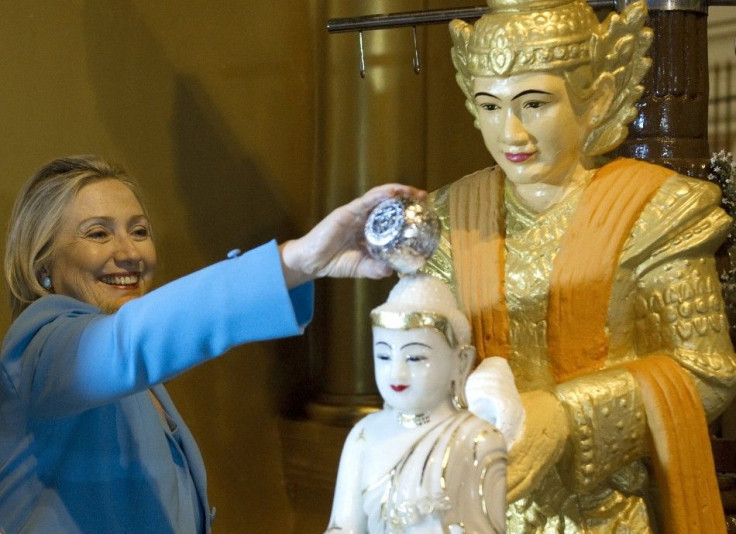 U.S. Secretary of State Clinton pours water over a statue of Buddha at the Shwedegon Pagoda in Yangon