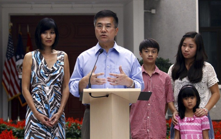 Locke, new U.S. ambassador to China, stands with his family outside their residence as he speaks to the media in Beijing