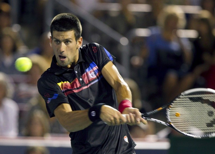 Serbia's Novak Djokovic hits a return to France's Jo-Wilfried Tsonga during his semi-final match at the Rogers Cup tennis tournament in Montreal
