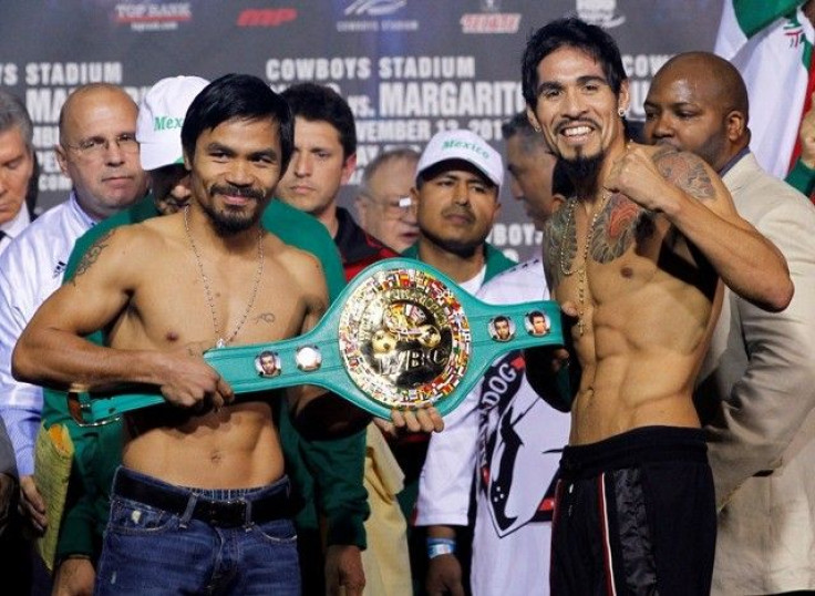 Manny Pacquiao of the Philippines (L) and Antonio Margarito of Mexico pose with the championship belt during the weigh-in for their upcoming WBC super welterweight championship fight at Cowboys Stadium