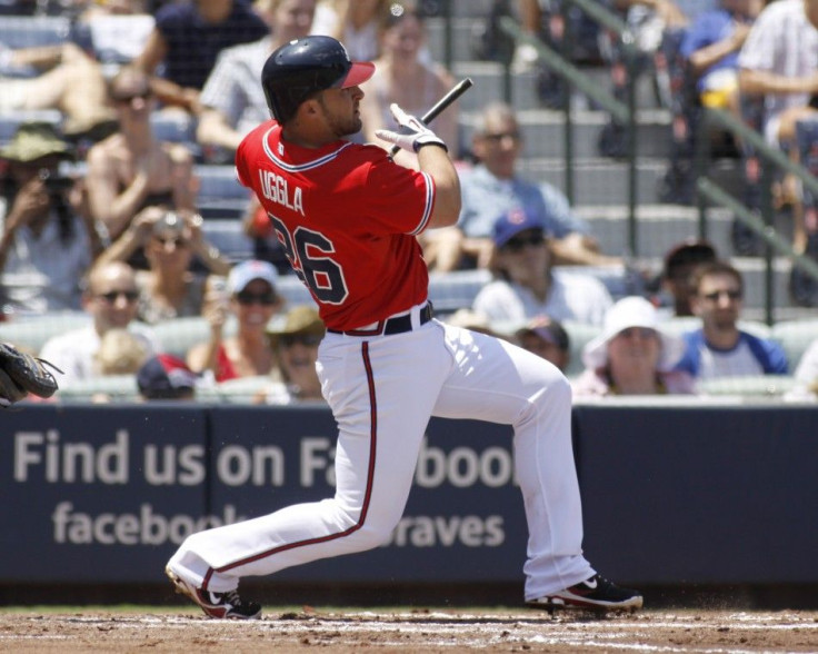 Braves batter Uggla watches his broken bat sacrifice fly in the first inning, scoring a run off of Cubs pitcher Garza at their MLB National League baseball game at Turner Field in Atlanta
