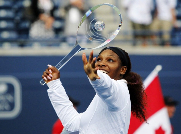 Williams of the US pretends to use the trophy as a tennis racket after defeating Stosur of Australia during their finals match at the Rogers Cup women&#039;s tennis tournament in Toronto