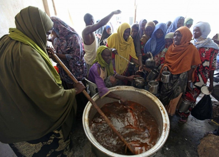 A displaced Somali prepares to serve food at a camp in Hodan district in capital Mogadishu